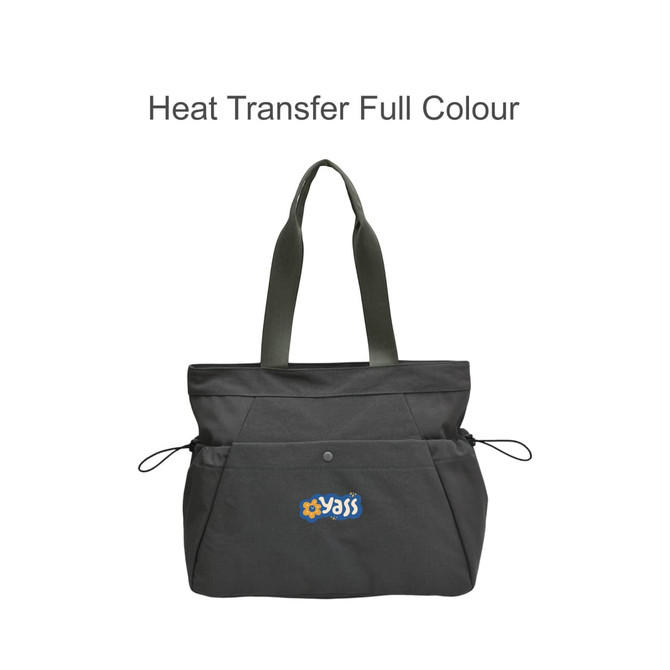 A grey tote bag with green straps, featuring a logo, side pockets, and yoga mat straps.