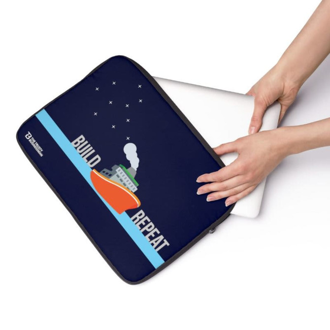 A neoprene laptop sleeve in navy blue, featuring a graphic of a boat and a logo, being held by hands.
