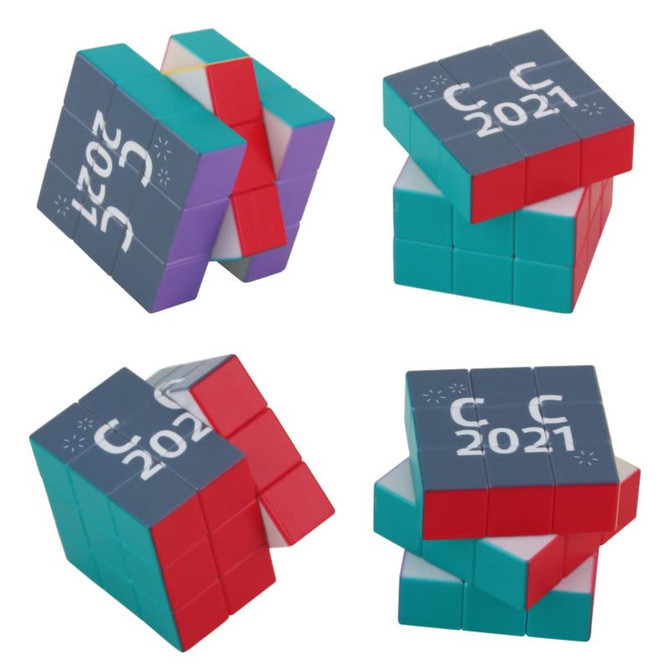 A twist cube puzzle in teal, purple, red, and white featuring a logo and the year 2021.