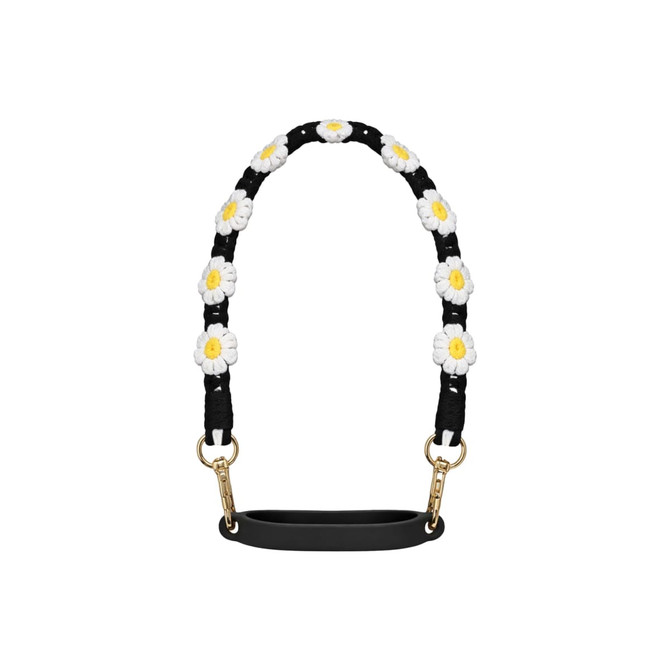 A drink bottle strap featuring a black background with woven white and yellow daisies and gold clips.