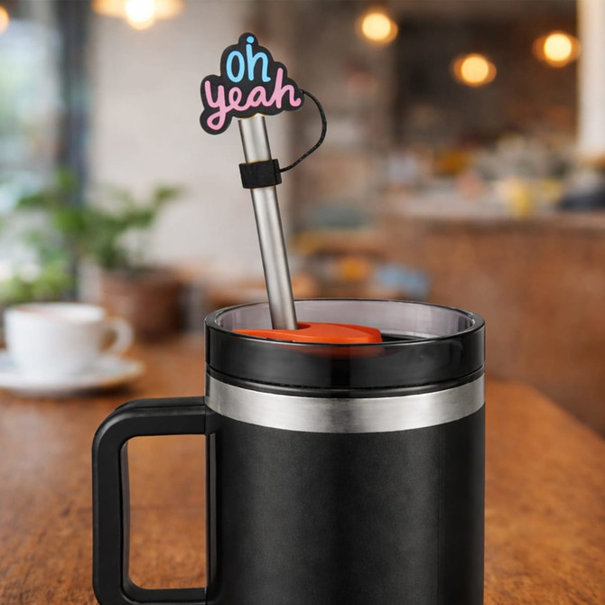 A drink bottle with a black exterior features a stainless steel straw and a vibrant pink custom shape straw cover.