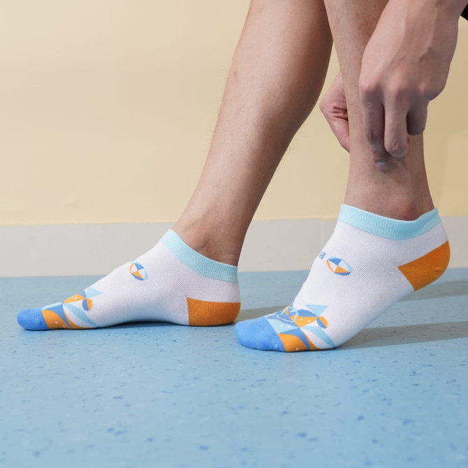 Low cut custom pattern socks in white, blue, and orange with a colourful design, featuring a logo on the side.