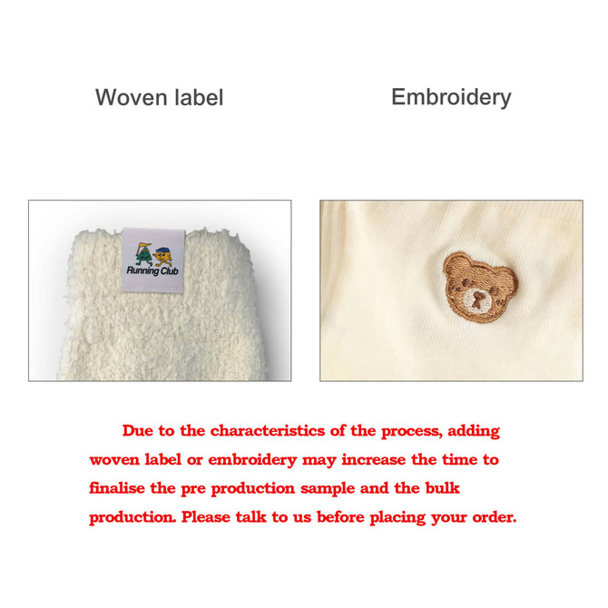 A close-up view of a woven label and embroidered design on a fabric, featuring a bear motif.