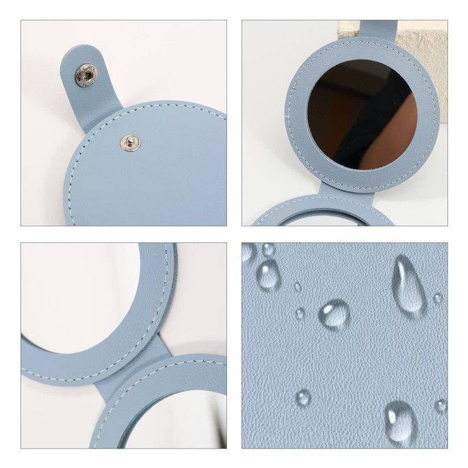 A round folding pocket mirror in light blue, featuring a smooth finish and water droplets on its surface.