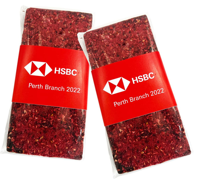 Two packets of premium chocolate-dipped freeze-dried raspberries, featuring a red and white branded wrapper.