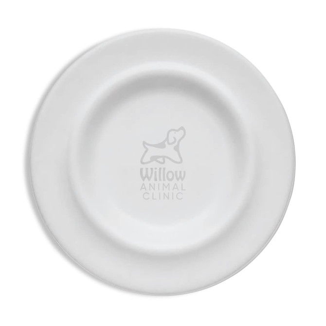 A white pet bowl with a circular design and an embossed logo in the centre.