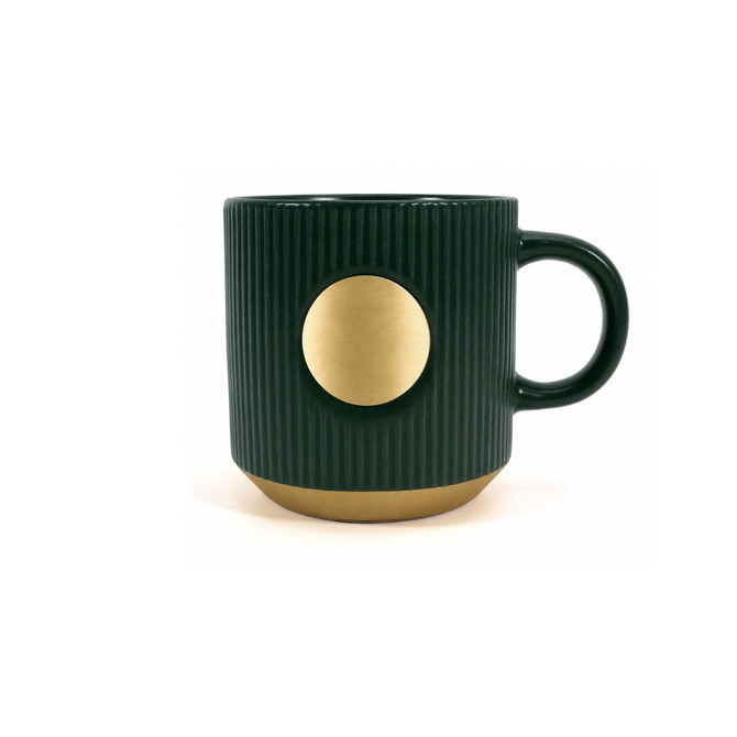 A ceramic coffee mug in dark green with a bronze circular accent and ribbed texture, featuring a logo.