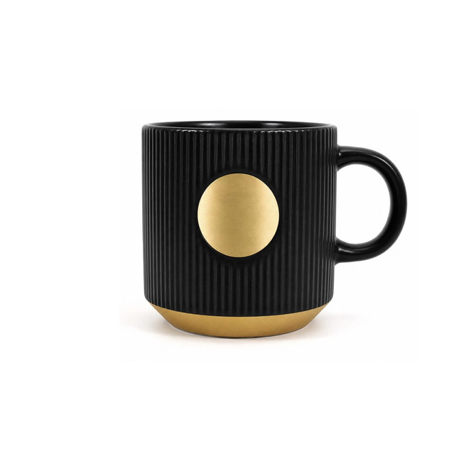 A ceramic coffee mug in black with a bronze medal accent and ribbed texture. Features a handle and a logo.