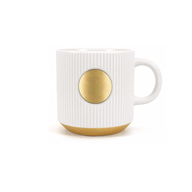 A ceramic coffee mug in white with ribbed texture and a bronze medal accent at the front.