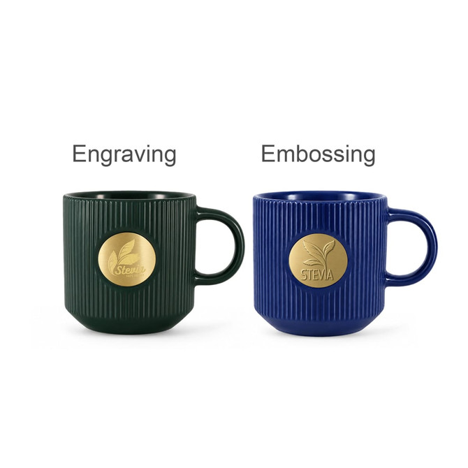 A green ceramic mug with a bronze medal and a blue ceramic mug with a bronze medal, both featuring ribbed designs.