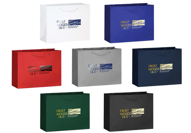 A collection of landscape tote bags in white, blue, red, green, black, and other colours with handles and logos.