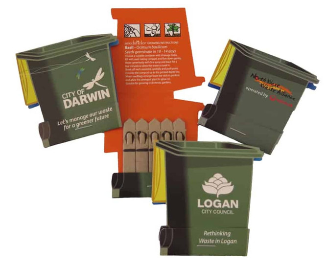 A set of miniature green and grey wheelie bins with promotional branding, arranged in a dynamic display.