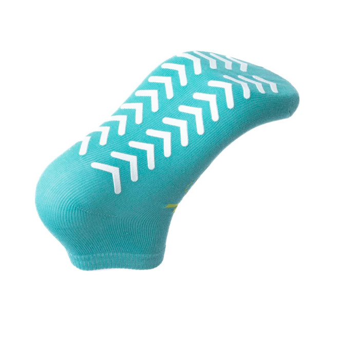 A pair of aqua blue custom short gripper socks with white non-slip grip patterns on the sole.