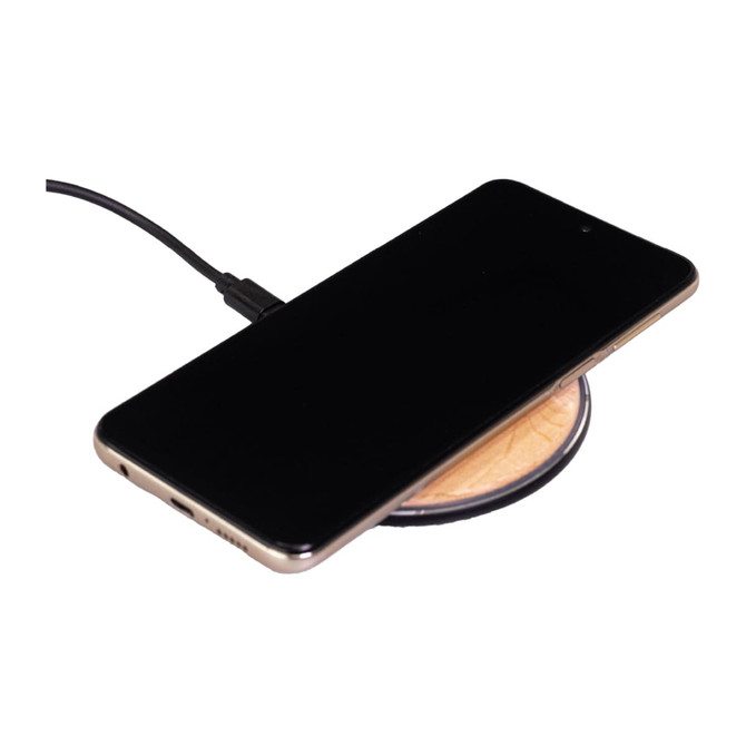 A bamboo wireless charger featuring a circular design with a smartphone placed on top, connected by a charging cable.