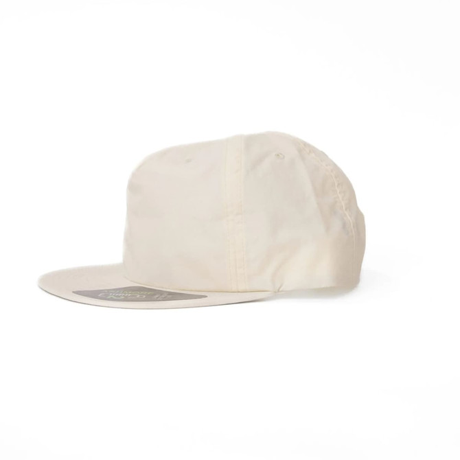 A cream-coloured cap with a rounded brim and a logo on the front.