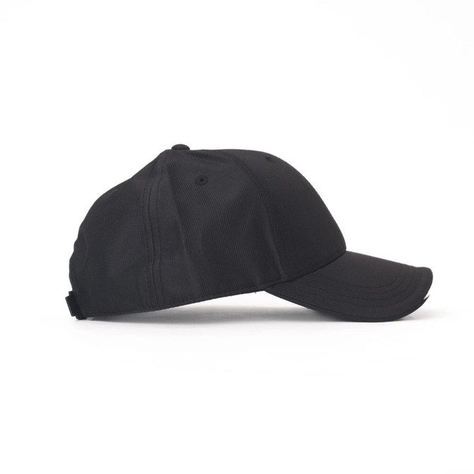 A black cap with a curved brim, featuring a logo on the side and ventilation holes.