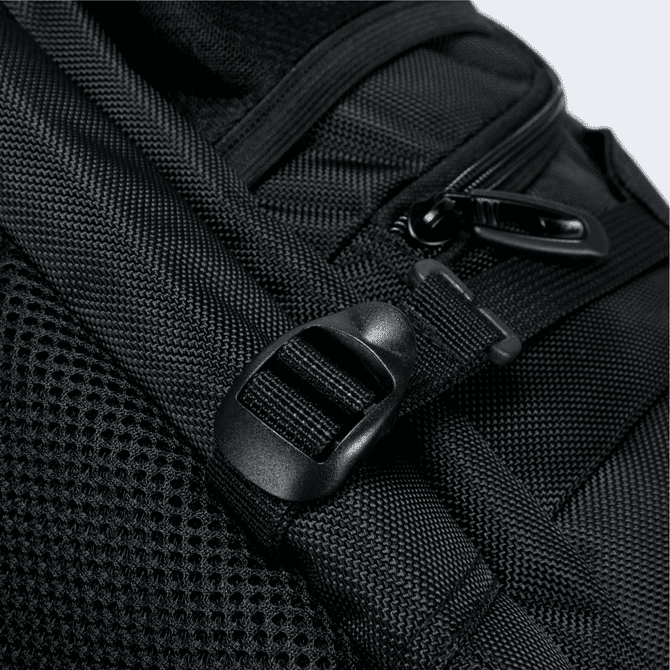 Close-up of a black Eiger backpack, highlighting the textured fabric and a strap buckle detail.