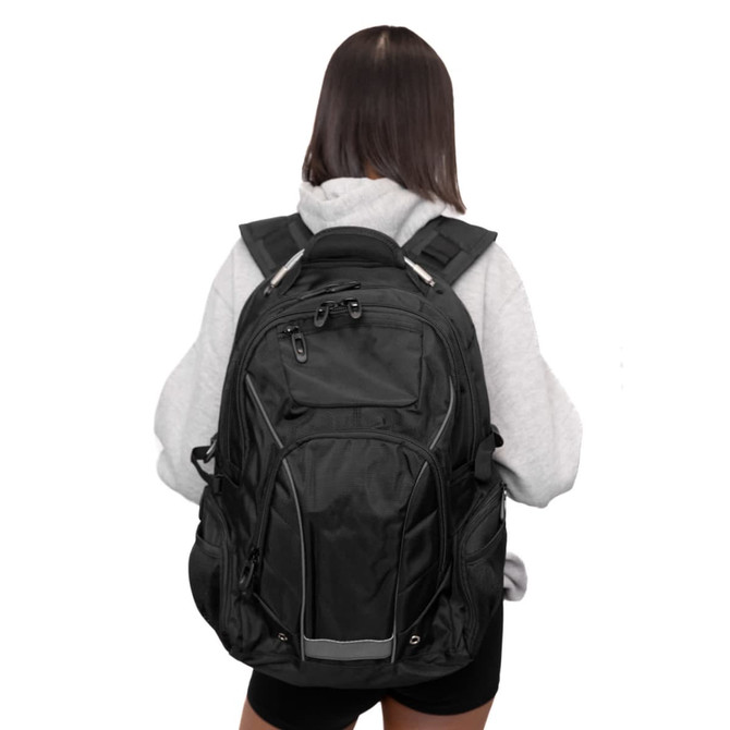 A black Eiger Backpack is being worn, featuring multiple compartments and a shoulder strap design.