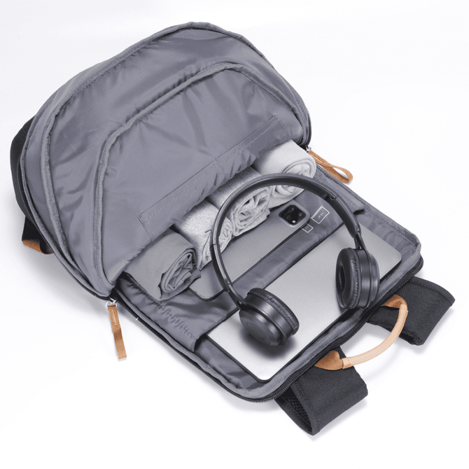A grey Fairweather Backpack open to reveal a laptop, headphones, and a rolled blanket inside. It has a logo.
