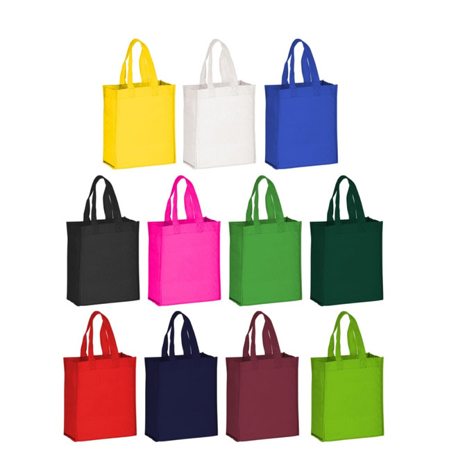 A collection of non-woven tote bags in various colours, including yellow, white, black, pink, green, navy, and burgundy.