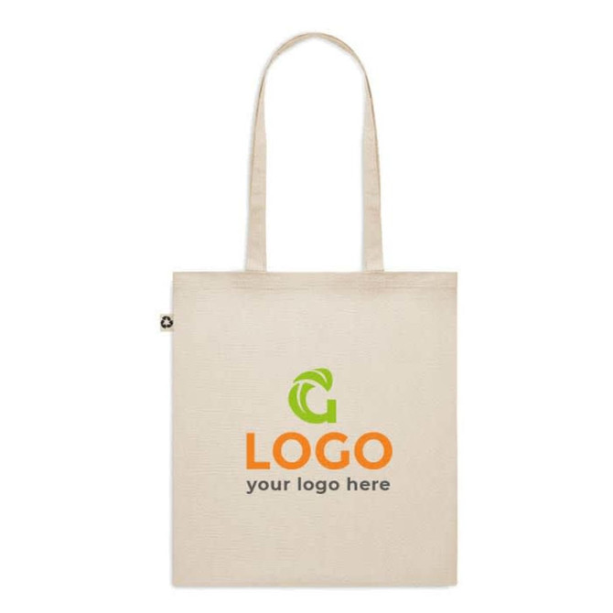 A beige recycled cotton tote bag with a logo on the front and two handles.