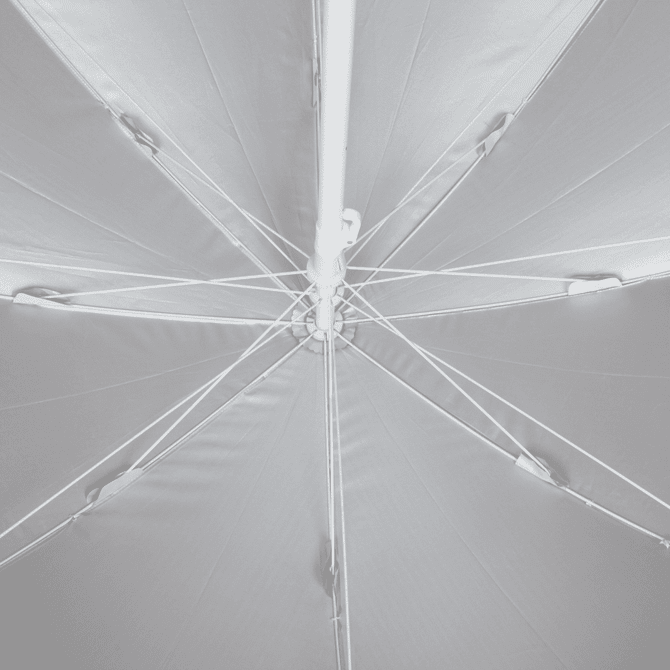 A white beach umbrella viewed from below, featuring a central pole and ribbing structure.