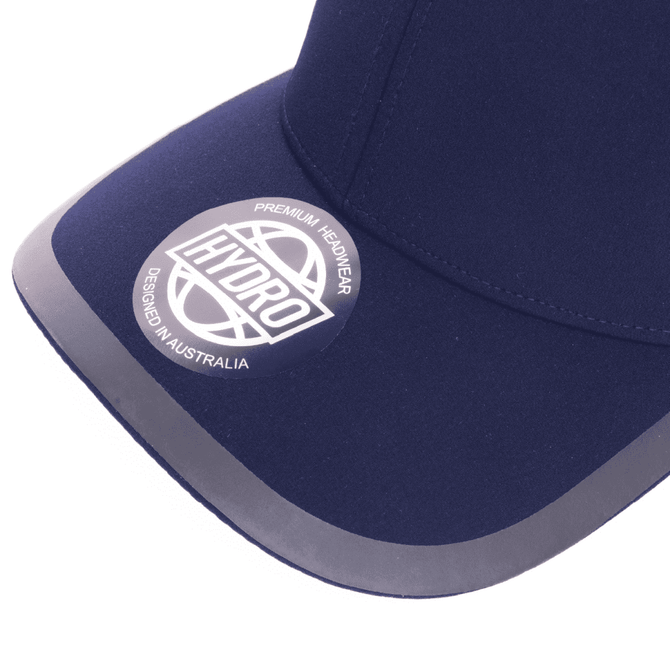 A navy cap featuring a curved peak and a logo on the front, designed for headwear.