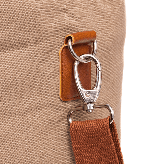 A close-up of a tan cooler bag featuring a metal clip and a brown strap. The bag has a textured fabric surface.