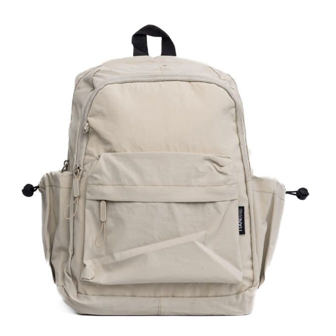 A beige backpack with multiple pockets, featuring a front zippered compartment and side mesh pockets. It has a logo.