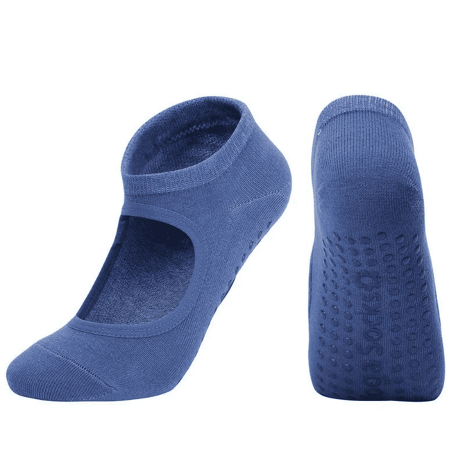 A pair of blue yoga socks with an open top and textured soles for grip, featuring a logo on the side.