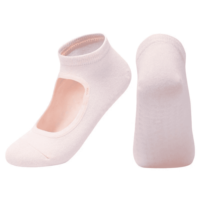 A pair of light pink yoga socks featuring an open top design and a snug fit. Brand logo is visible on the socks.