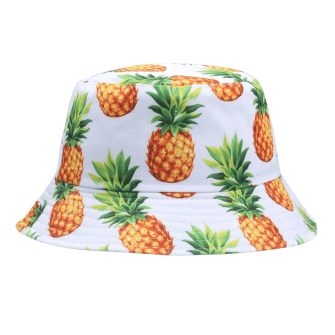 A bucket hat featuring a vibrant pineapple print on a white background, with a soft, wide brim and a logo.