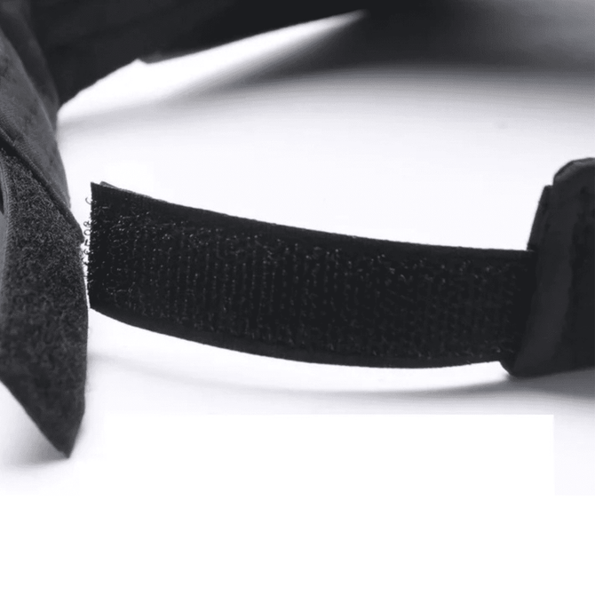 A black sun visor with a Velcro strap for adjustability, showcasing its textured material.