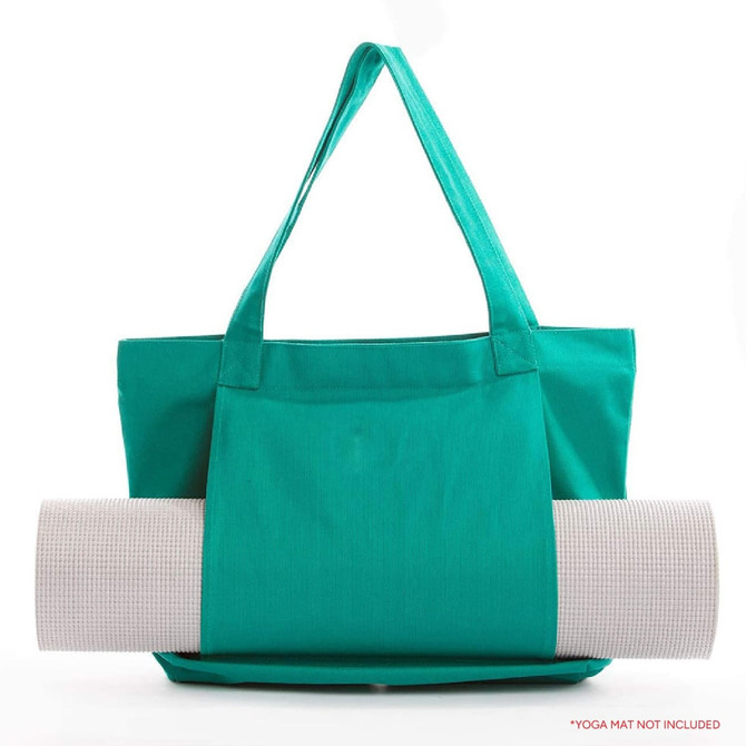 A teal canvas bag displays a rolled yoga mat partially secured, featuring a logo on the side.