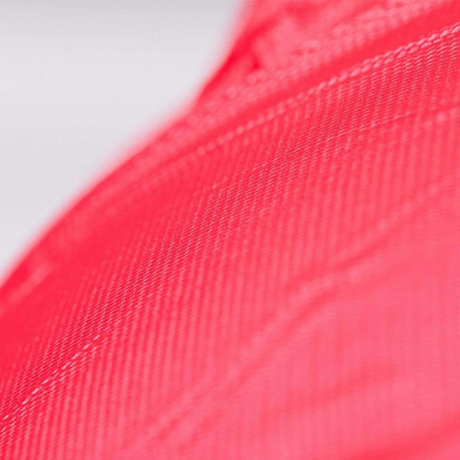 A close-up of a bright pink PVC material, showcasing its textured surface and vibrant colour.