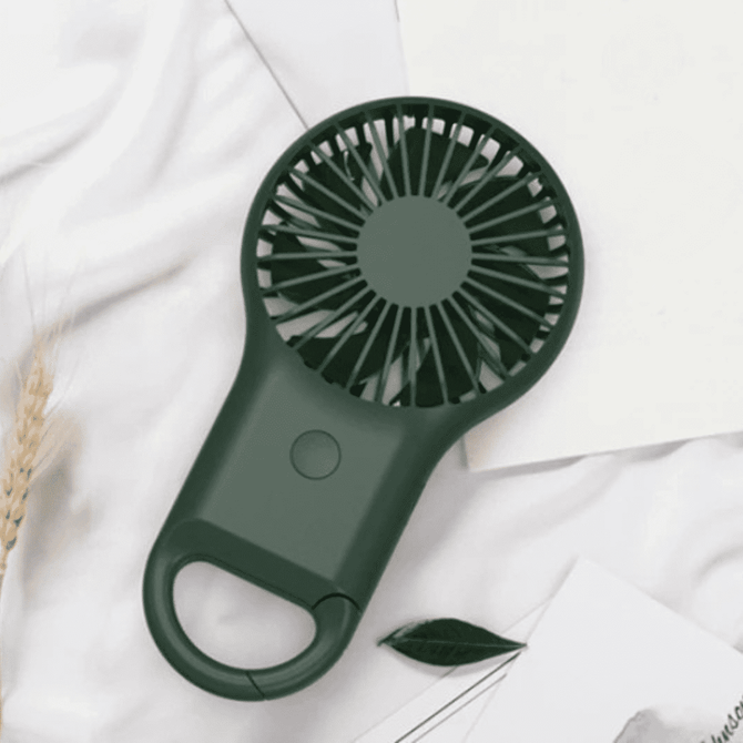 A portable pocket fan in dark green with a handle, featuring a circular fan design.
