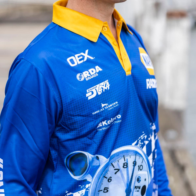 A blue and yellow long sleeve fishing polo featuring a logo and a dynamic sublimated design.