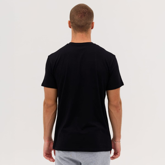 A man wearing a black Everyday Tee, viewed from the back, with grey shorts. The tee has a logo on it.