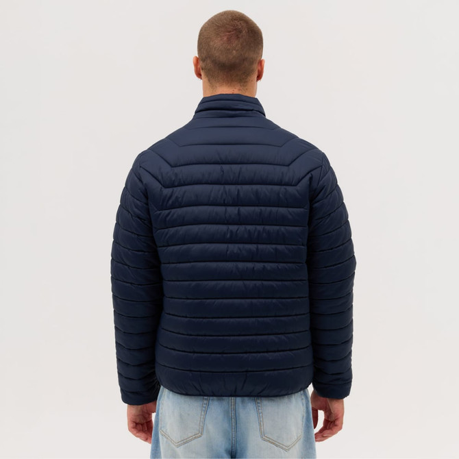 A puffer jacket in navy blue, featuring a quilted design, viewed from the back on a model.