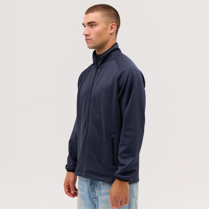 A navy Summit Bonded Jacket worn by a model, featuring a zip front and side pockets. The jacket includes a logo.