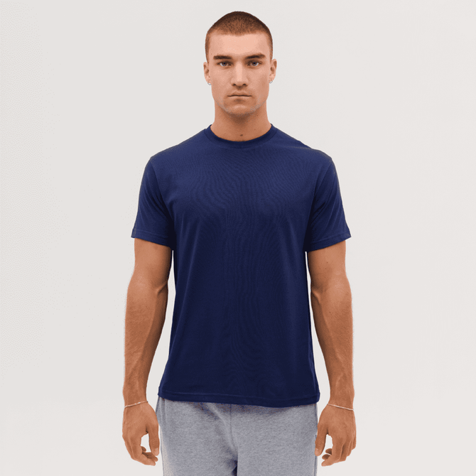 A navy blue T-shirt displayed on a male model, featuring short sleeves and a round neckline. It has a logo.
