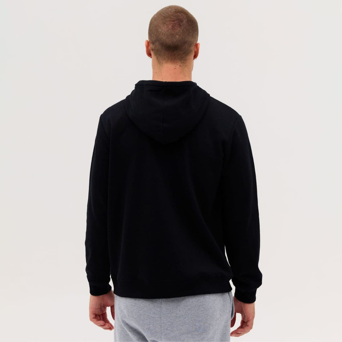 A black zip hood with a hooded design, viewed from the back, worn over grey pants. It has a logo on the clothing.