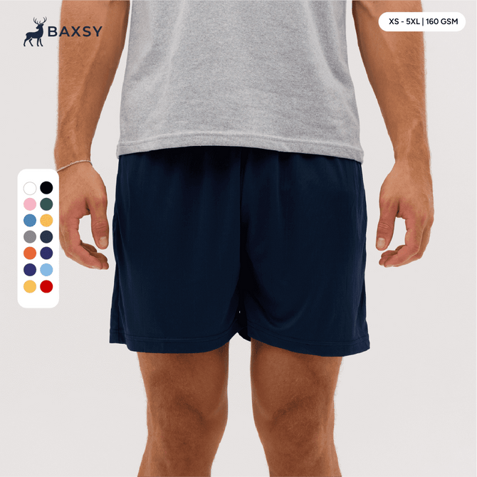 Navy shorts displayed on a model, featuring an elastic waistband and side pockets. Includes a colour selection chart.