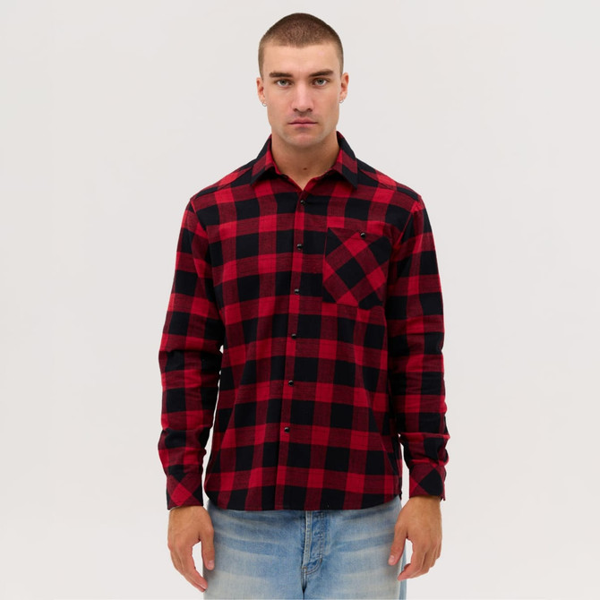 A long sleeve flannel shirt in red and black check pattern with a chest pocket. features a logo.