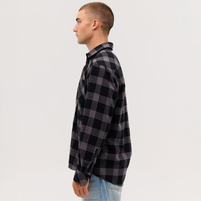A long sleeve flannel shirt in black and grey check patterns, featuring a button-up design and a collar.