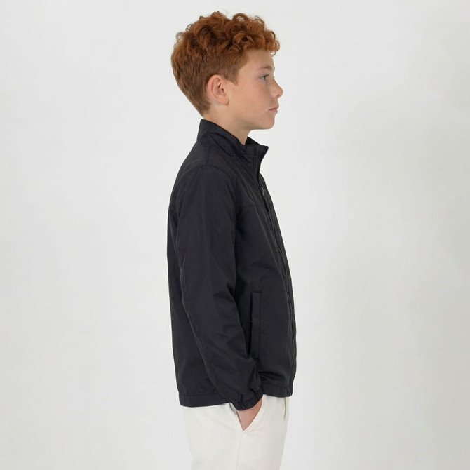 A youth jacket in black, featuring a collar and zip, displayed on a model from the side.
