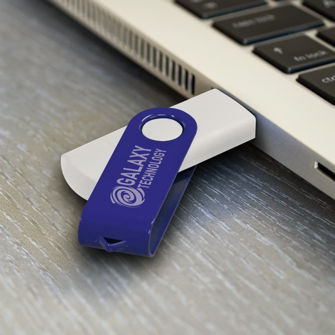 A purple and white Helix 8GB dual flash drive connected to a laptop, featuring a logo.