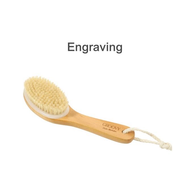 A dry brushing body brush with a wooden handle, soft bristles, and a loop for hanging. Features branding on the handle.