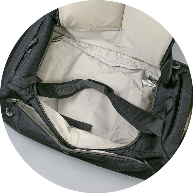 A black Osprey Daylite Duffle Bag with a spacious interior and a strap visible inside.