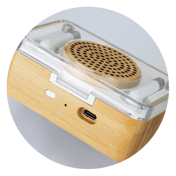 A bamboo wireless speaker features a wooden base with a clear top and integrated earbuds. It has a USB-C port.